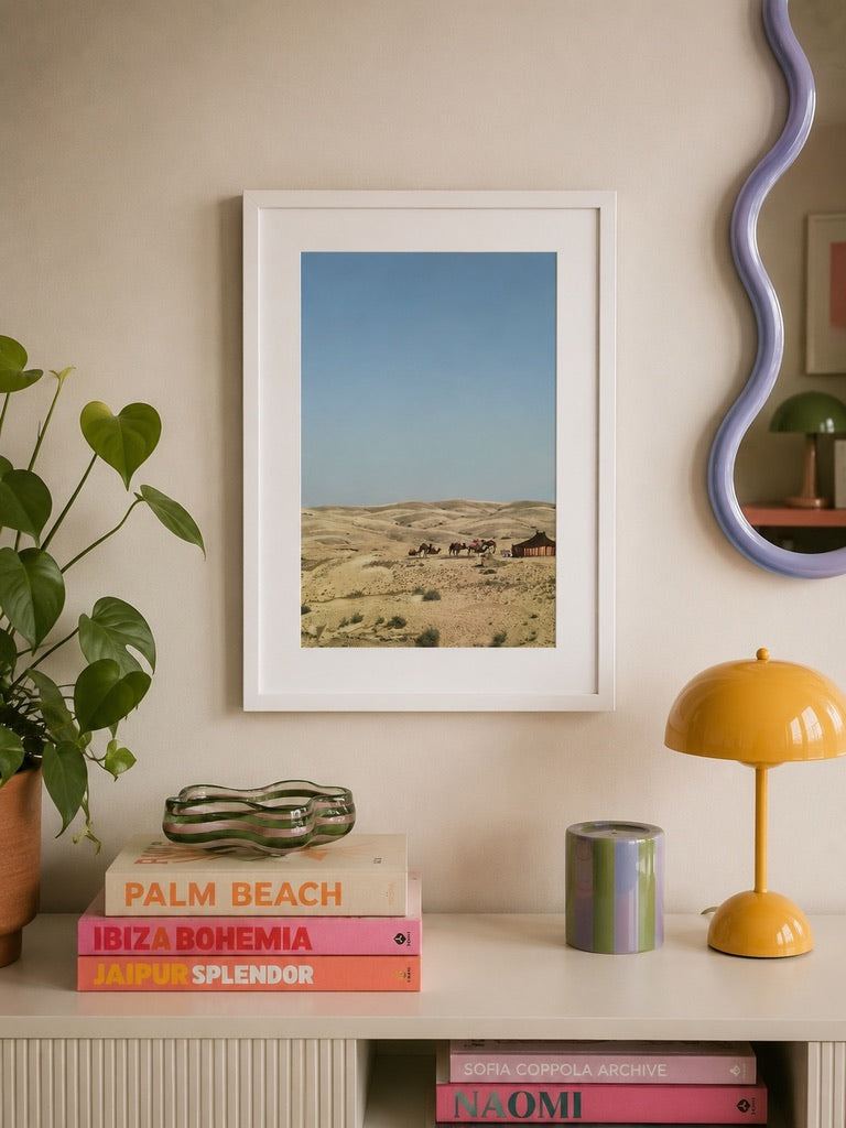 A3 Agafay Desert print styled on a shelf with books and a yellow table lamp