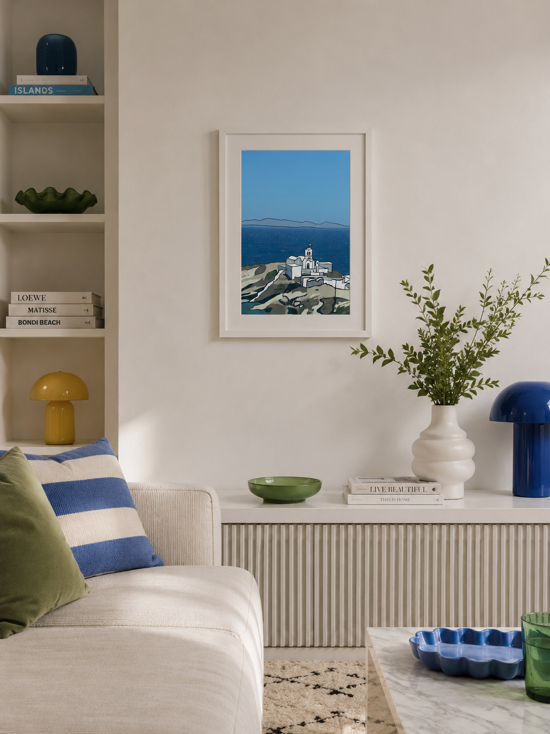 A3 Sifnos print framed in a sunlit living room with a sofa and shelving