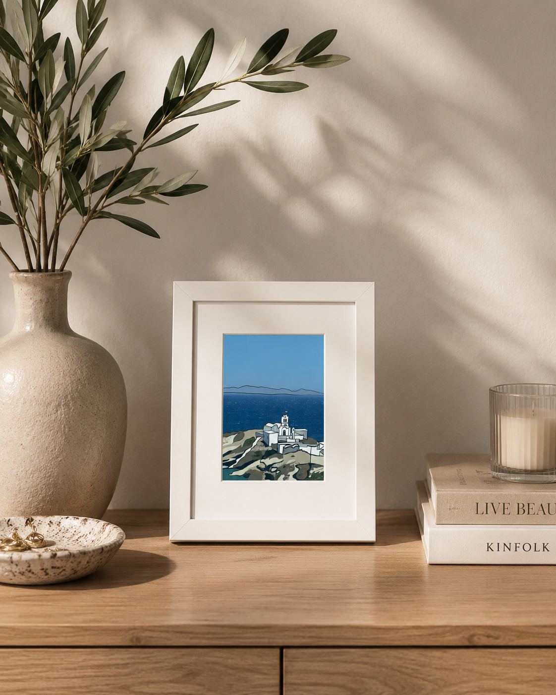 A5 Sifnos print styled on a table with an olive branch and candle