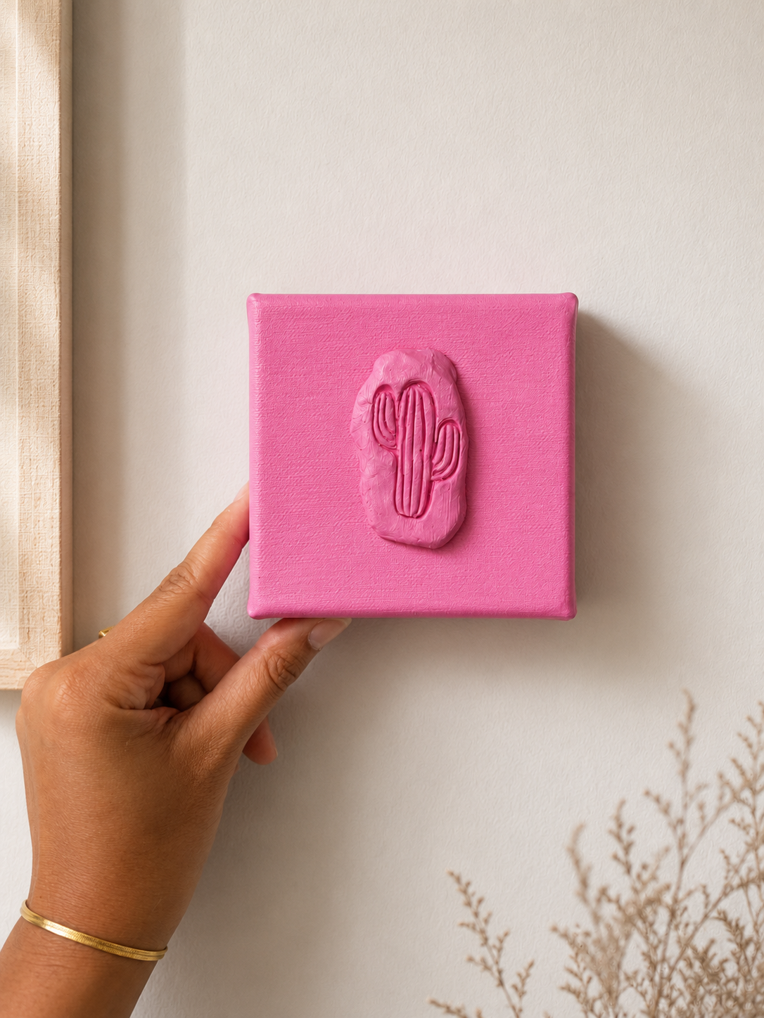 Cactus Rosa Grande — a small pink ceramic cactus emblem mounted on a pink box canvas, photographed and held against a plain white background.