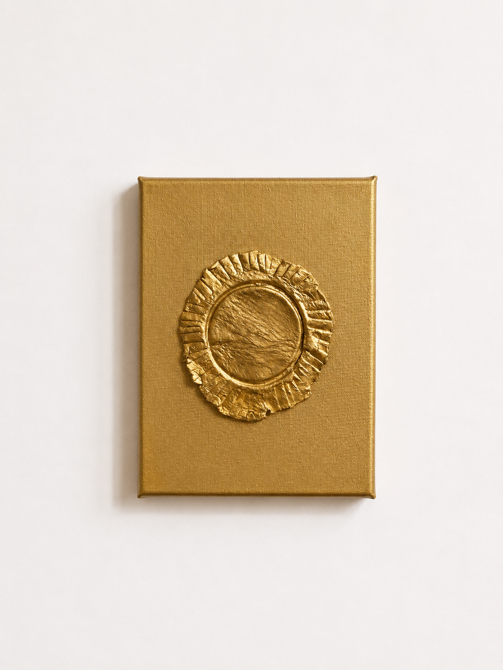 Eclipse ceramic art on gold canvas, raised metallic gold ruffled circular design on white background