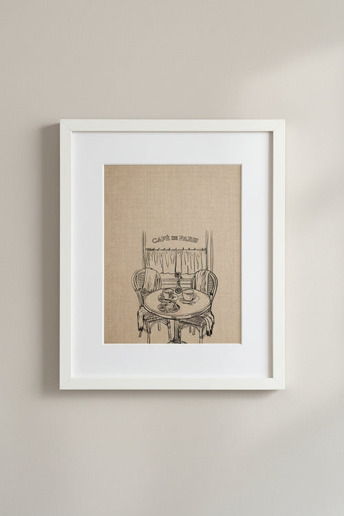 Framed Café de Paris print of a bistro table and chairs