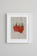 Framed Picante print of red chilli peppers on a wall