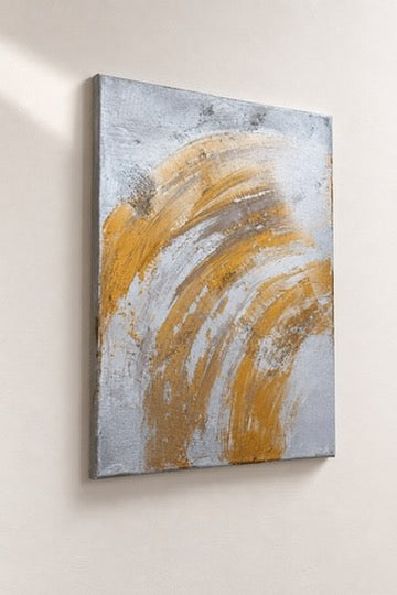 Gold and silver abstract acrylic painting on canvas, sweeping arc brushstrokes, against a wall, different angle