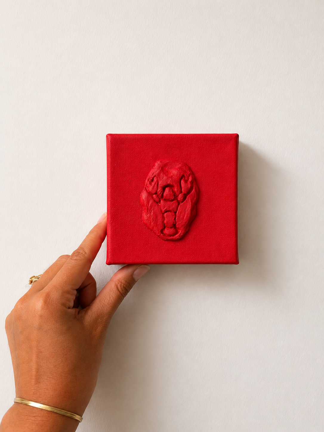 Lobster Rosso Grande — a small red ceramic sacred heart emblem mounted on a red box canvas, photographed against a plain white background.