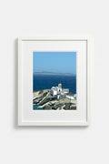 Sifnos print styled on a shelf with a blue lamp and books
