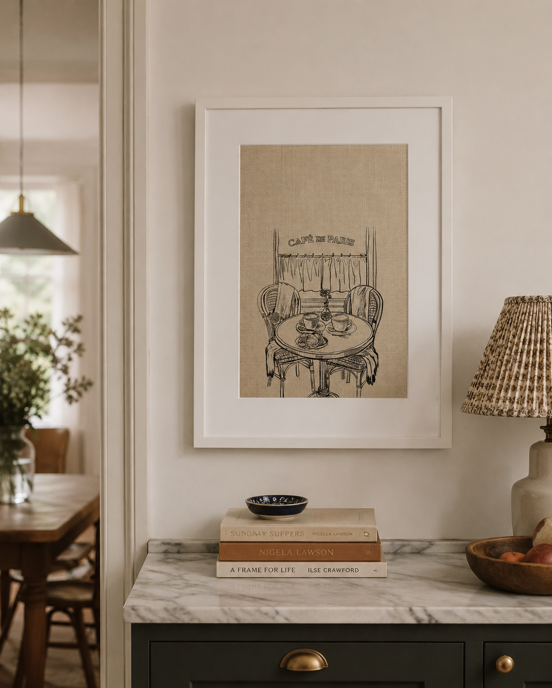 a3 framed Café de Paris print of a bistro table and chairs over a console table