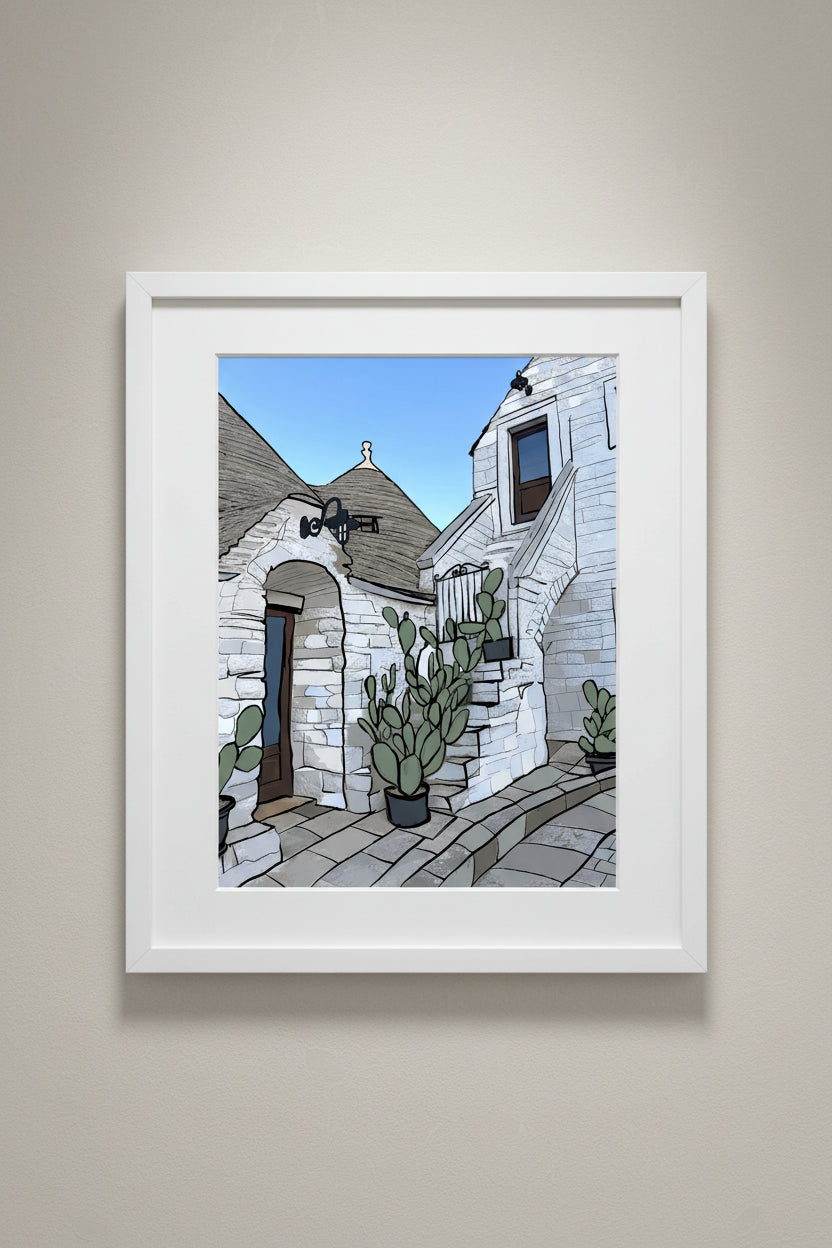 Framed Alberobello print of trulli houses and cacti hung on a wall