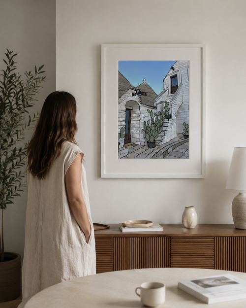 A3 Alberobello print framed on a wall beside a woman for scale